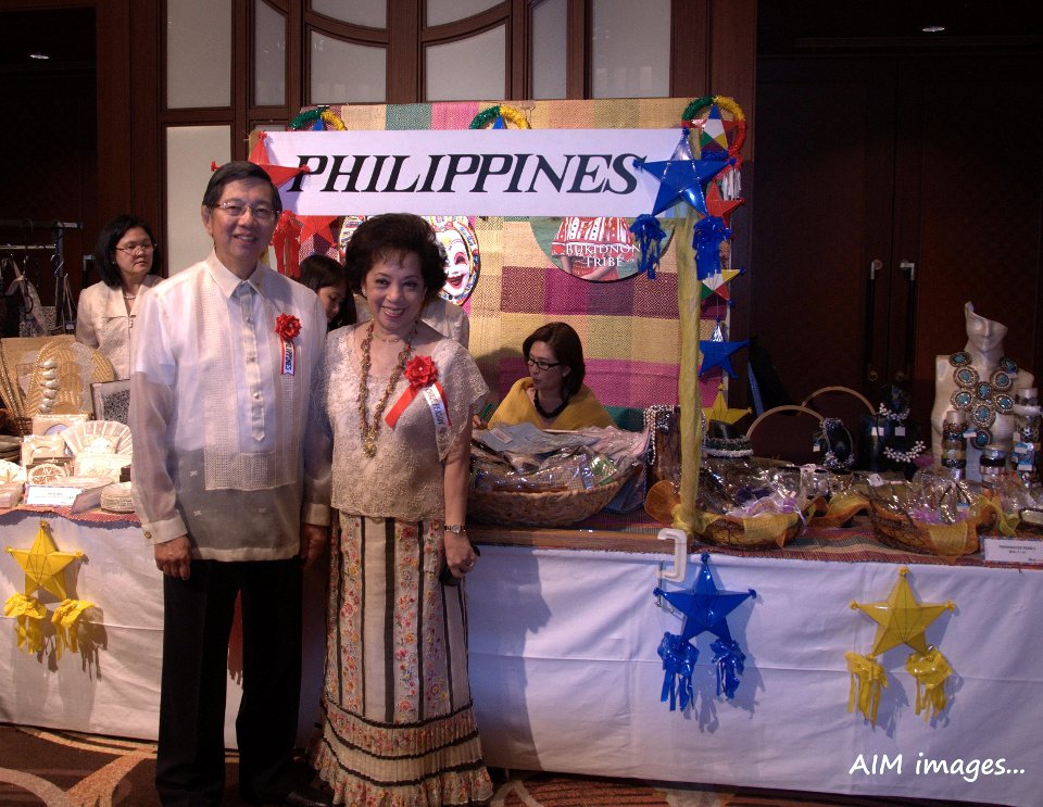 Ambassador Manuel M. Lopez and Madame Lopez in front of Philippine handicrafts booth.